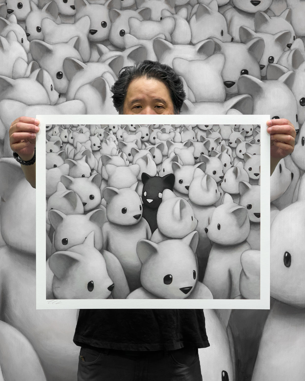 Artist Luke Chueh holding up standard edition of Crowded