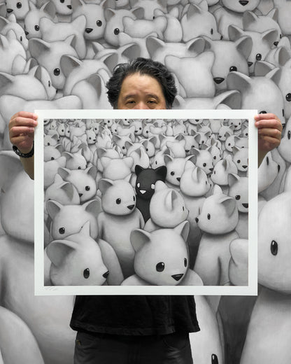 Artist Luke Chueh holding up standard edition of Crowded