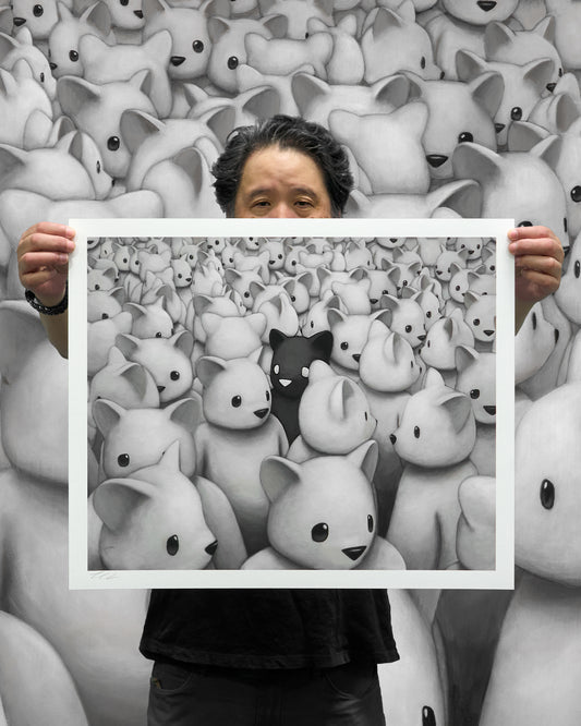 Artist Luke Chueh holding up standard edition of Crowded