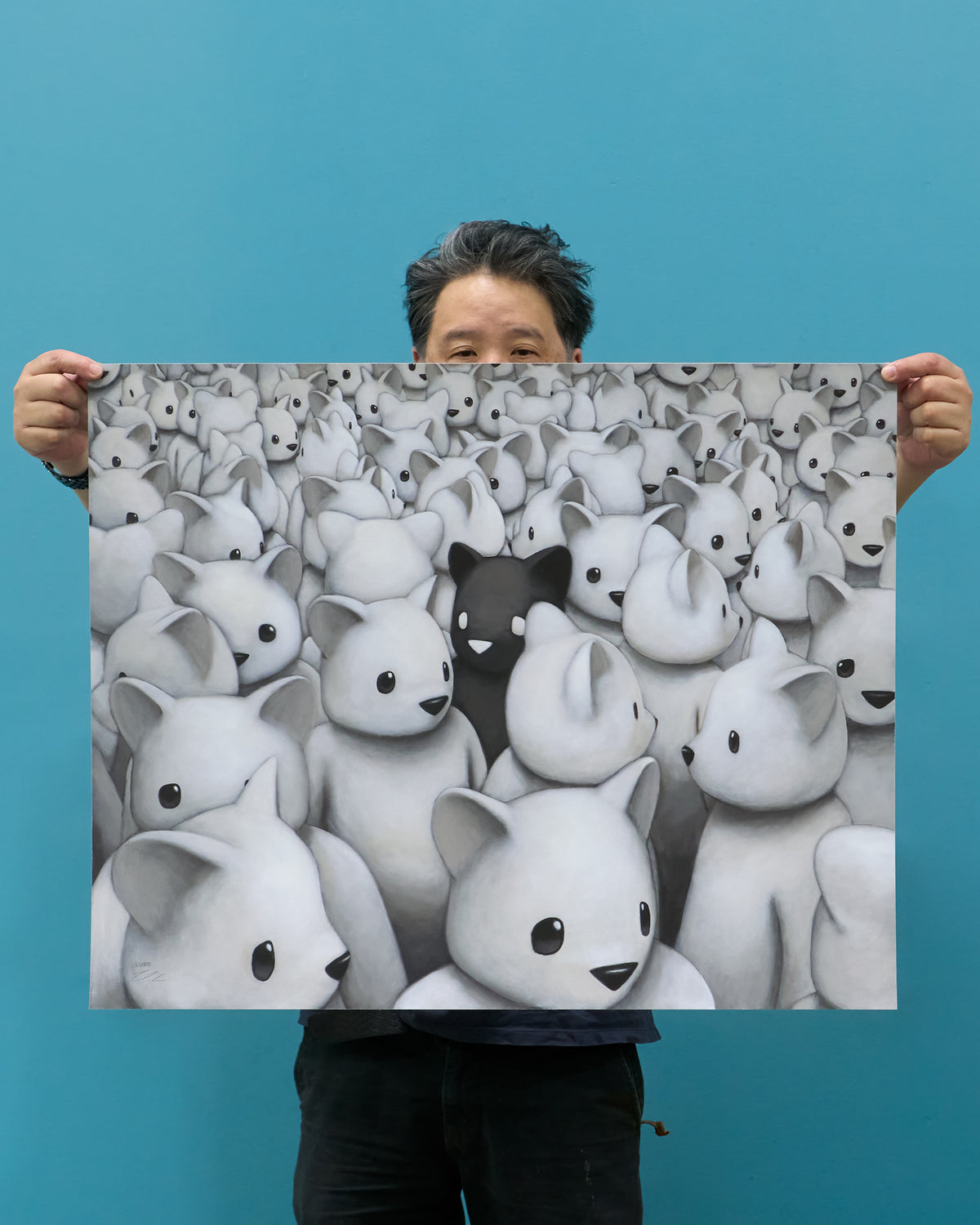 Artist Luke Chueh holding up Maximum Bearage edition of Crowded